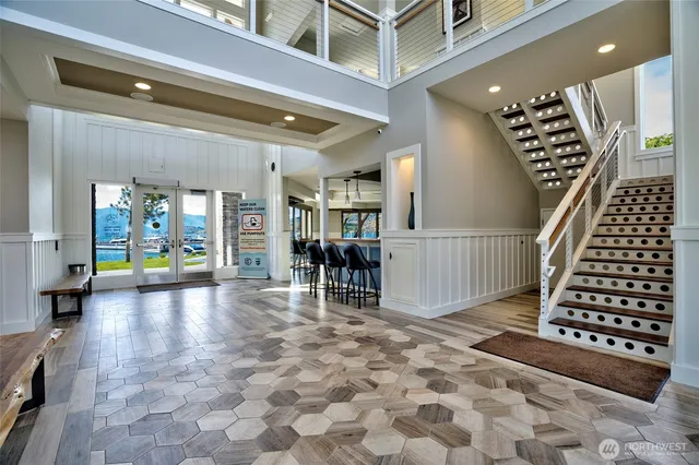 a living room with furniture a flat screen tv and a large window