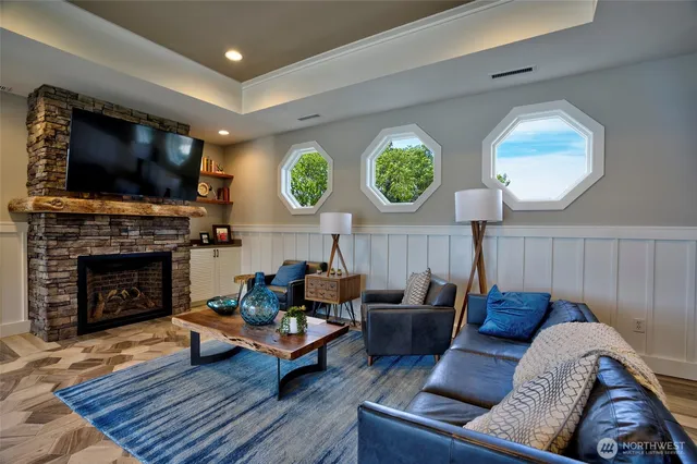a living room with furniture a rug and a large window