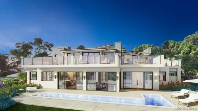 a front view of a building with a garden and plants