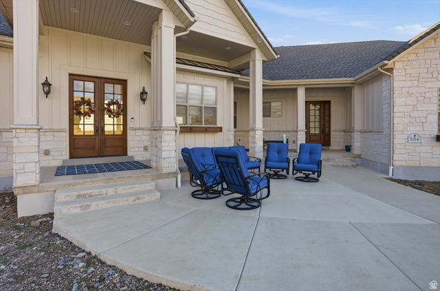 534 East Fish Hatchery Road Mantua, UT 84324 - Photo 62 of 87 View of exterior entry with french doors, board and batten siding, and roof with shingles