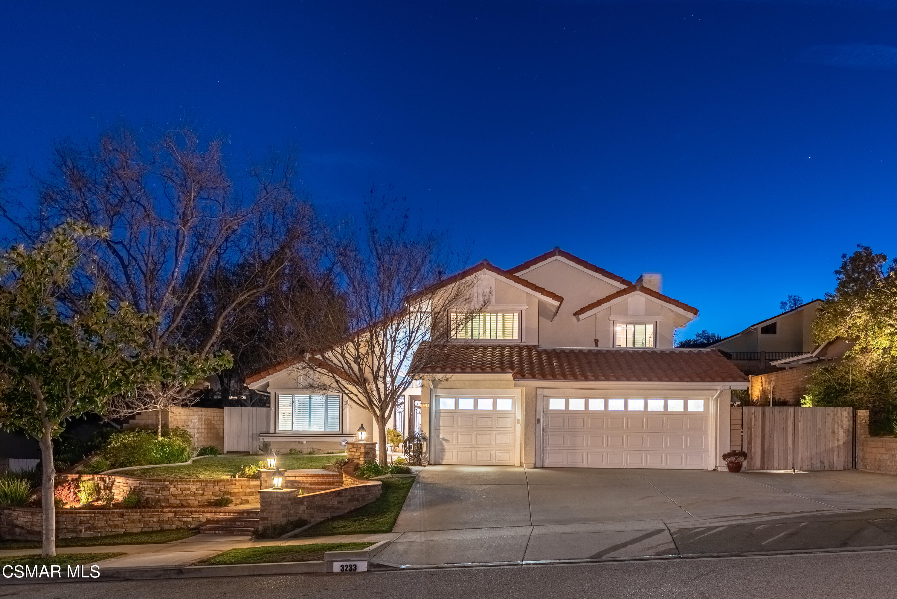 a front view of a building with a yard