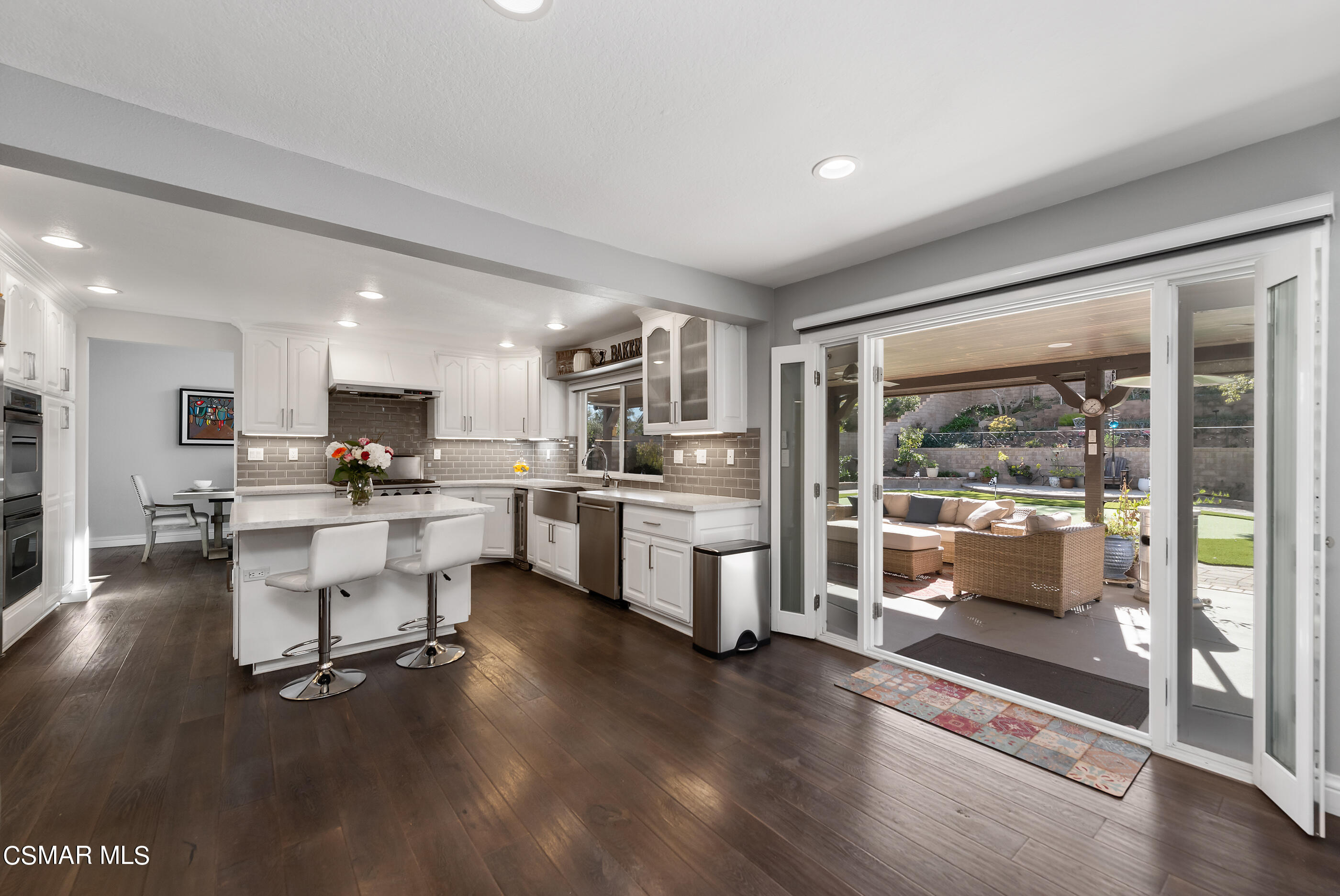 3233 Crazy Horse Drive Simi Valley, CA 93063 - Photo 32 of 65 a kitchen with white cabinets and counter space