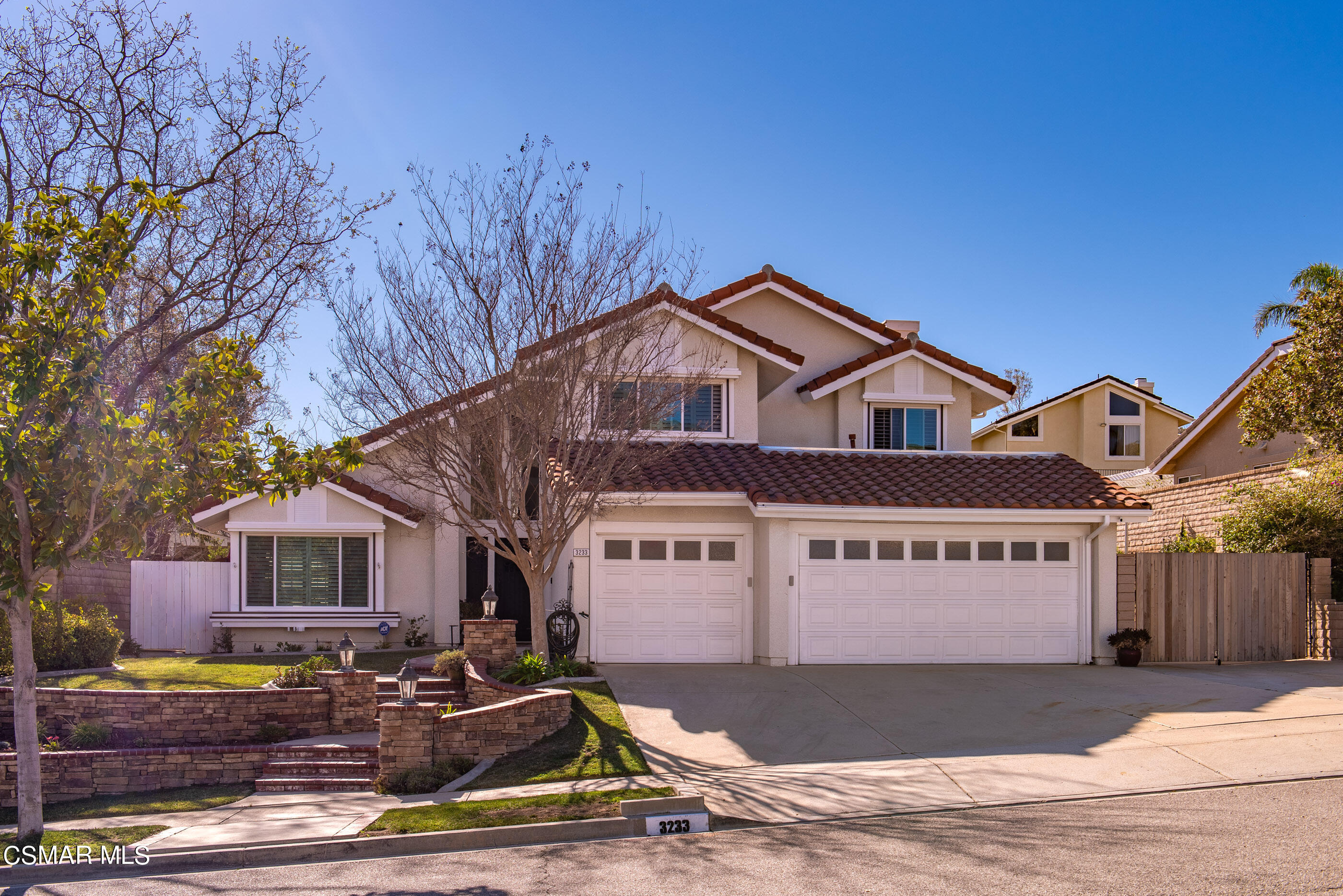 3233 Crazy Horse Drive Simi Valley, CA 93063 - Photo 64 of 65 a view of a white house with large trees and wooden fence