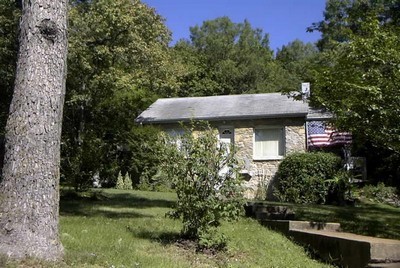 a view of a wooden house with a yard