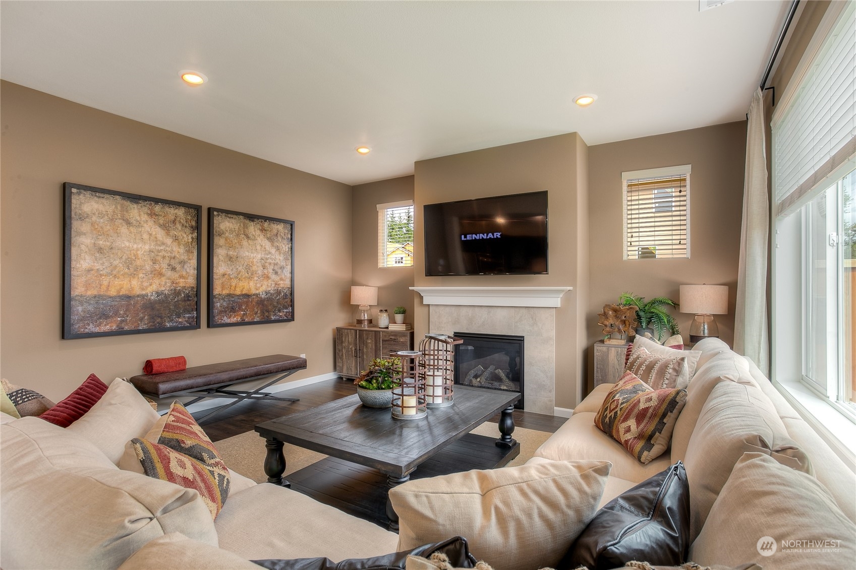 20828 42nd Drive Southeast, Unit 145 Bothell, WA 98021 - Photo 3 of 15 a living room with furniture a fireplace and a flat screen tv