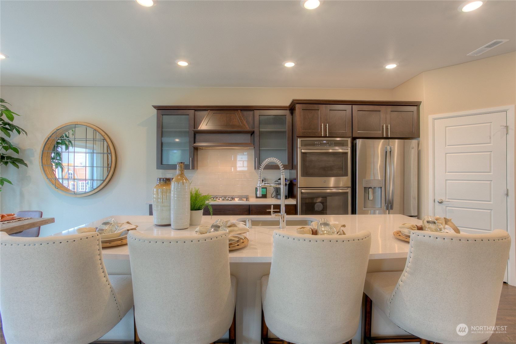 20828 42nd Drive Southeast, Unit 145 Bothell, WA 98021 - Photo 7 of 15 a room with a table chairs and a large mirror