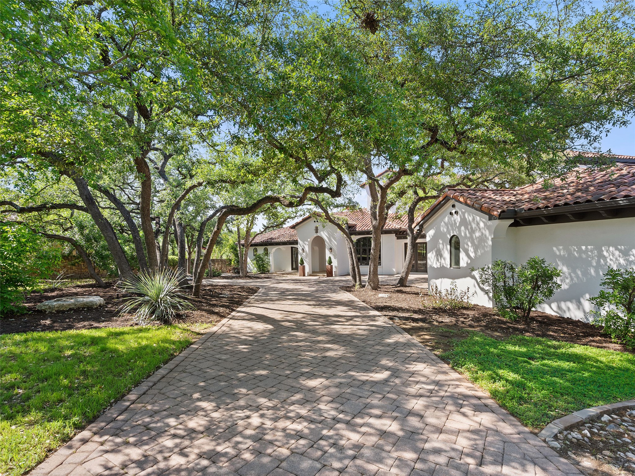 11620 Musket Rim Street Austin, TX 78738 - Photo 11 of 32 a front view of a house with a garden and tree