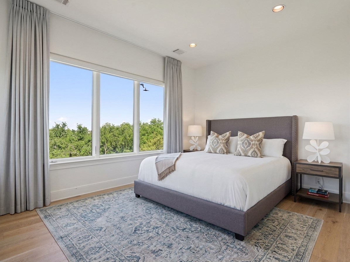 11620 Musket Rim Street Austin, TX 78738 - Photo 18 of 32 a large bed sitting in a bedroom next to a window
