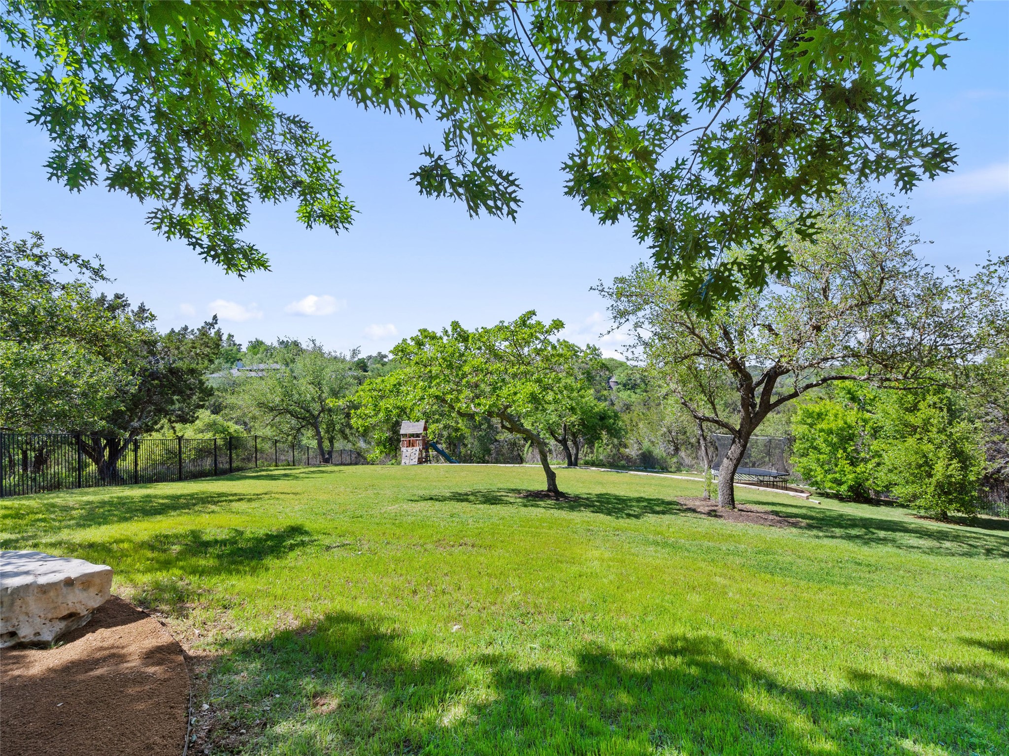 11620 Musket Rim Street Austin, TX 78738 - Photo 30 of 32 a view of green field with trees in the background