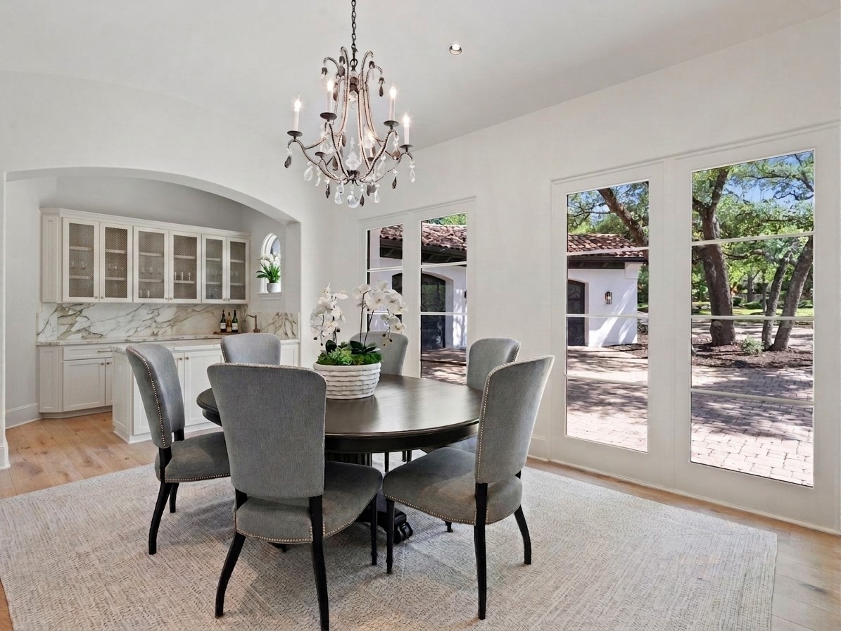 11620 Musket Rim Street Austin, TX 78738 - Photo 5 of 32 a view of a dining room with furniture window and wooden floor