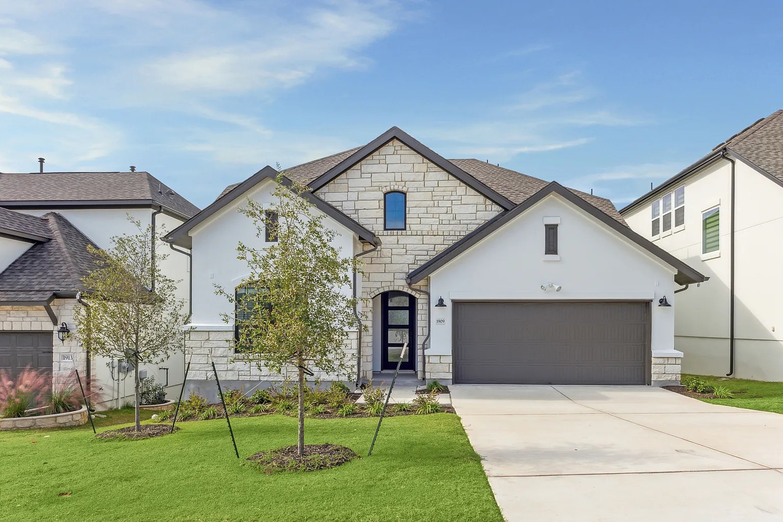 1909 Varese Path Leander, TX 78641 - Photo 1 of 40 A striking facade with white stucco and stone accents provides inviting curb appeal.