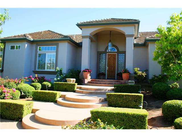 1035 Sleeping Indian Road Oceanside, CA 92057 - Photo 2 of 25 Stunning rose bushes & manicured hedge leads up to the front door