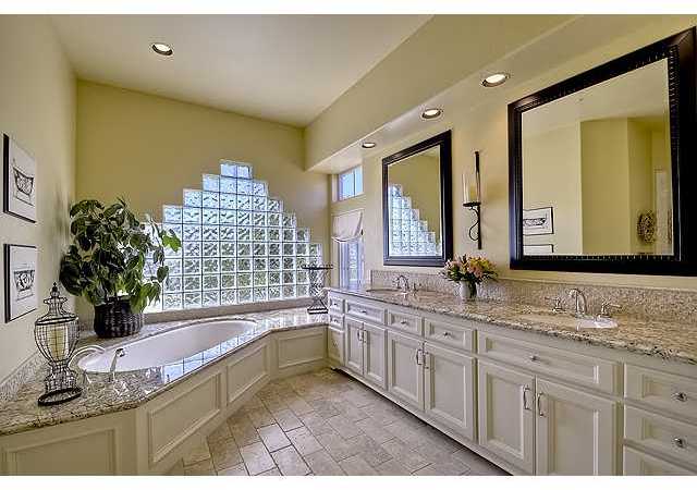 1035 Sleeping Indian Road Oceanside, CA 92057 - Photo 12 of 25 Tastefully upgraded master bath is bathed in natural light. Soothing soaking tub, travertine floors, granite counters and large walkin closet