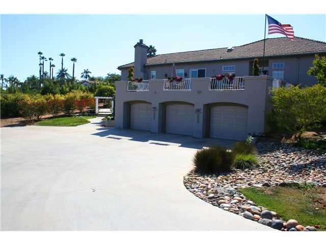 1035 Sleeping Indian Road Oceanside, CA 92057 - Photo 15 of 25 Large 3 car garage located underneath the sunny patio deck. Huge paved driveway area for extra parking / basketball court etc