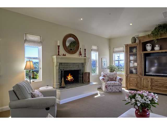 1035 Sleeping Indian Road Oceanside, CA 92057 - Photo 25 of 25 The great room features a cozy fireplace and large entertainment center. The center is not attached but DOES convey with the home.