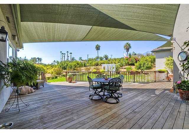 1035 Sleeping Indian Road Oceanside, CA 92057 - Photo 5 of 25 Leading off the great room is the awning covered shady side deck looking out over the grassy back yard and orchard