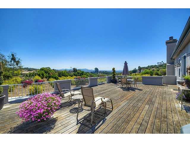 1035 Sleeping Indian Road Oceanside, CA 92057 - Photo 6 of 25 Large, sunny view deck off the kitchen offers quiet & sweeping views of So Morro Hills. Perfect for outdoor dining, BBQ and evening entertaining under the stars