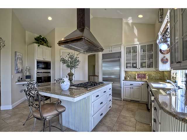 1035 Sleeping Indian Road Oceanside, CA 92057 - Photo 8 of 25 Stunning country kitchen. Large center island cooktop with long granite counters and plenty of storage. All stainless steel appliances & built in fridgerator.
