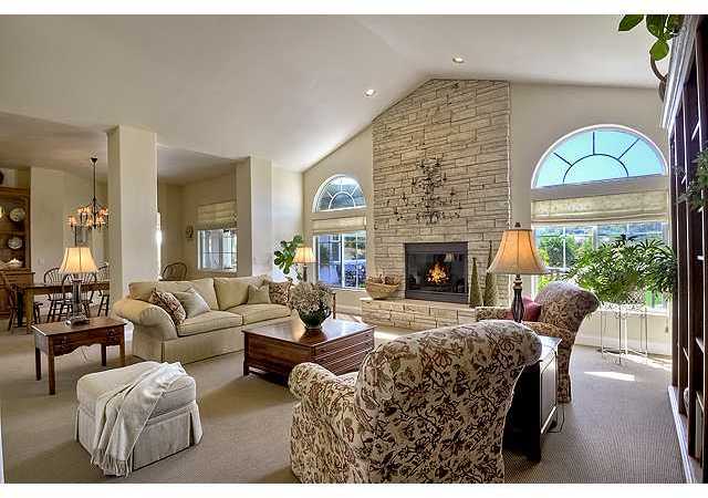 1035 Sleeping Indian Road Oceanside, CA 92057 - Photo 9 of 25 The pitched volume ceilings of the living room welcome you into the front entry and is anchored by an impressive stone fireplace & hearth.