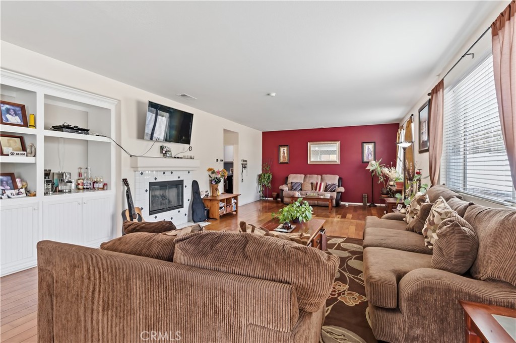 152 Alabaster Loop Perris, CA 92570 - Photo 16 of 29 a living room with furniture fireplace and a flat screen tv