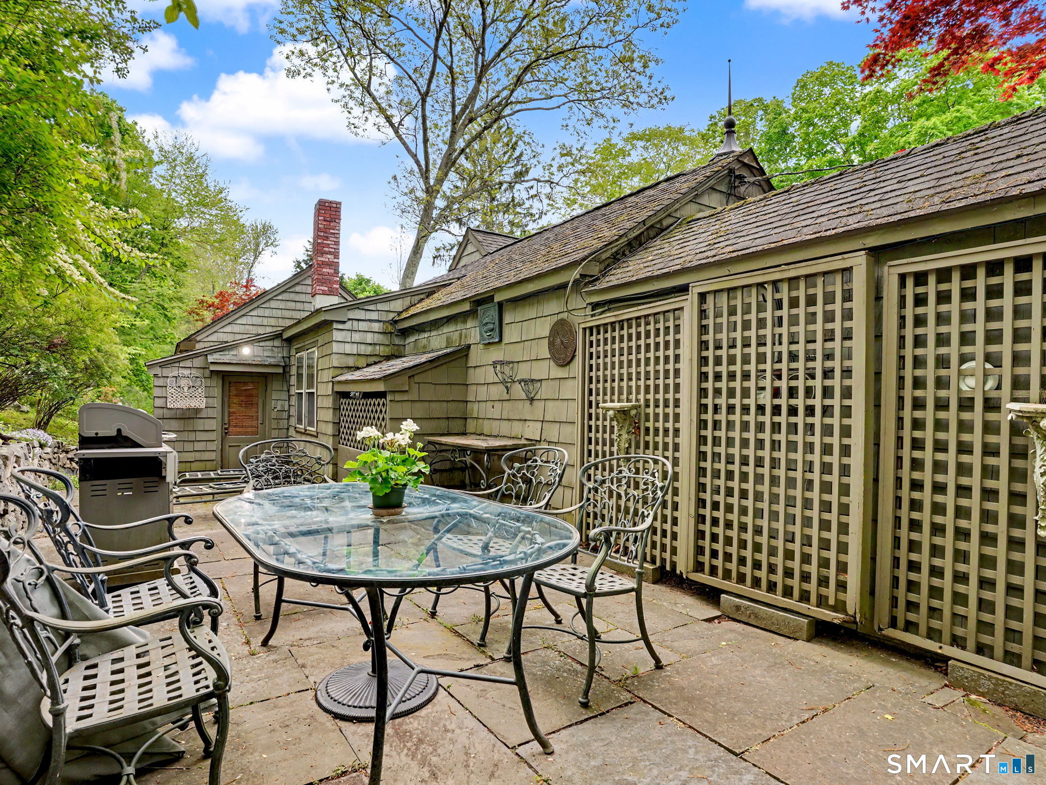 42 Cannondale Road Weston, CT 06883 - Photo 19 of 31 a backyard of a house with table and chairs