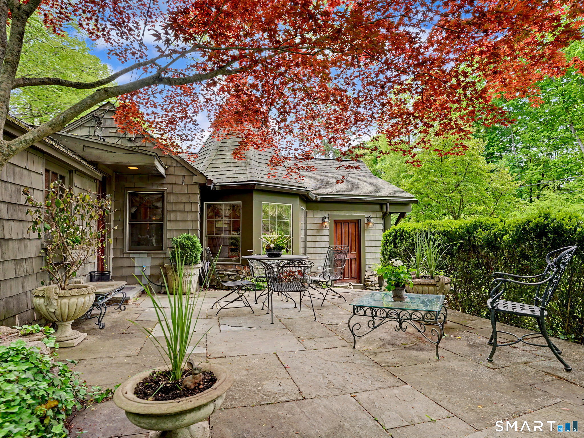 42 Cannondale Road Weston, CT 06883 - Photo 2 of 31 a view of the house with backyard outdoor seating and plants