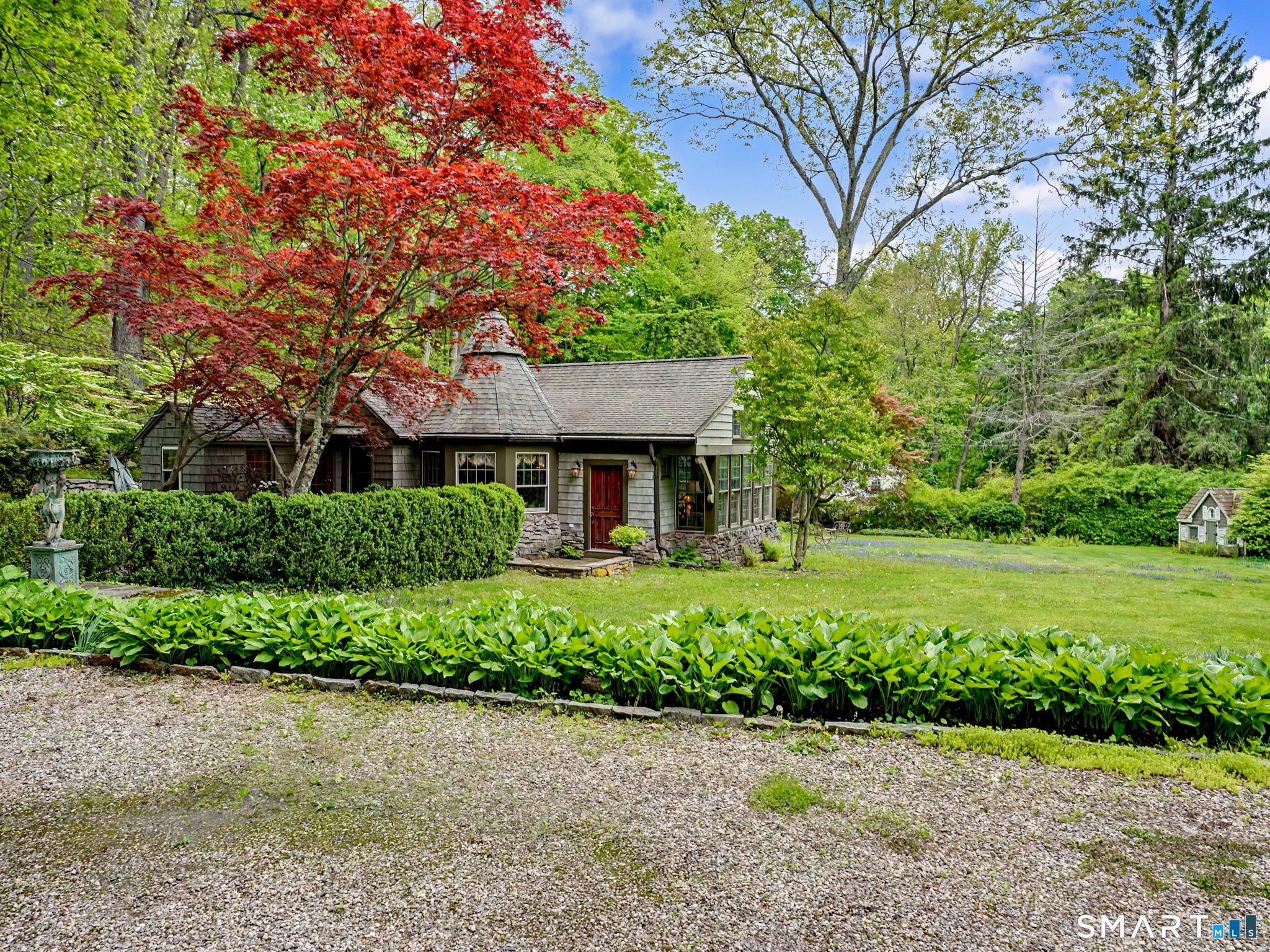 42 Cannondale Road Weston, CT 06883 - Photo 28 of 31 a front view of a house with a yard and potted plants