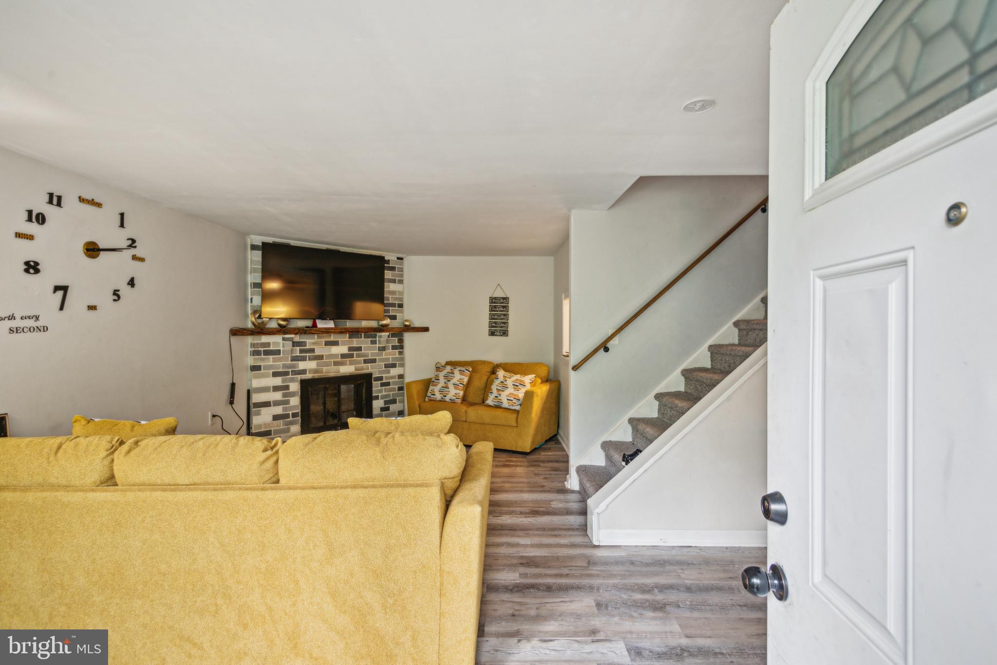 1008 Timber Creek Road Clementon, NJ 08021 - Photo 13 of 24 a living room with furniture a fireplace and a flat screen tv