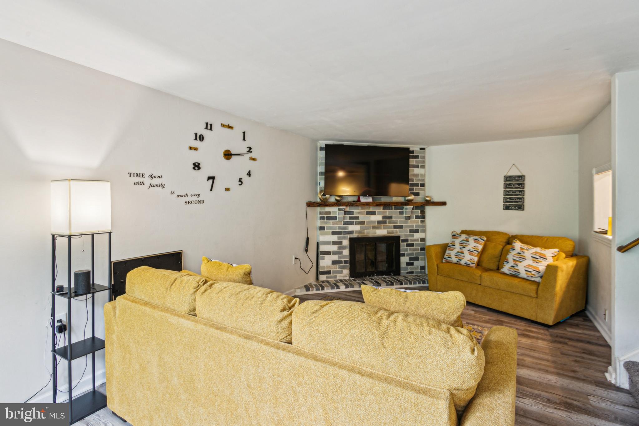 1008 Timber Creek Road Clementon, NJ 08021 - Photo 14 of 24 a living room with furniture a flat screen tv and a fireplace