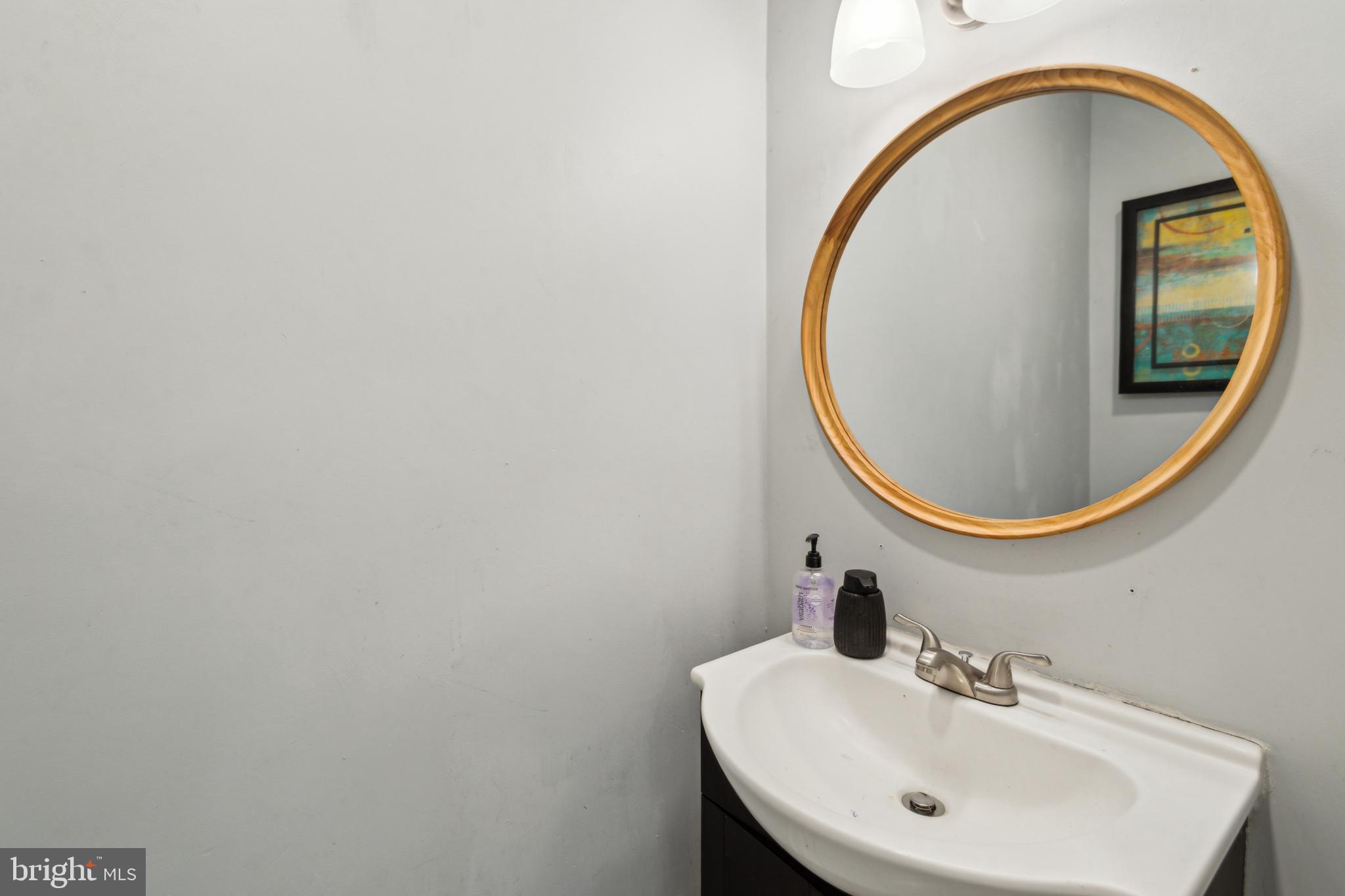 1008 Timber Creek Road Clementon, NJ 08021 - Photo 21 of 24 a bathroom with a sink and a mirror
