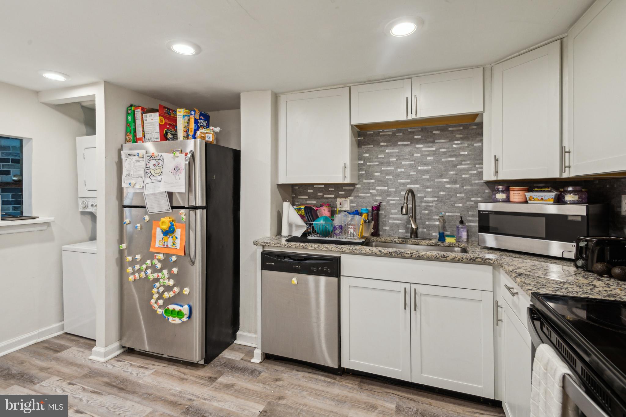 1008 Timber Creek Road Clementon, NJ 08021 - Photo 22 of 24 a kitchen with stainless steel appliances granite countertop a refrigerator and a stove top oven