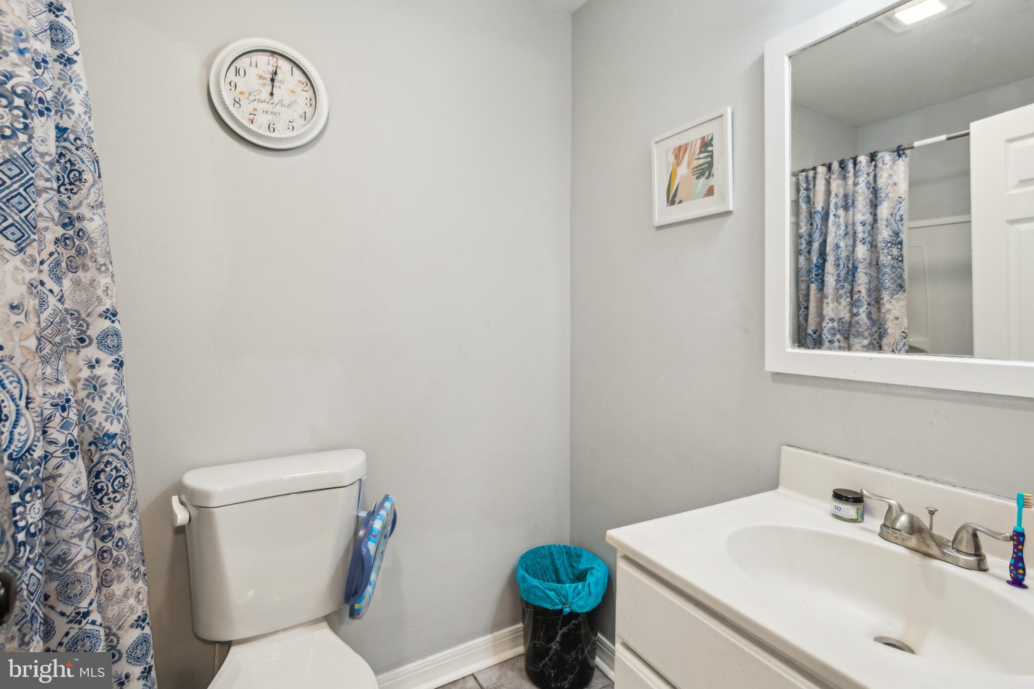 1008 Timber Creek Road Clementon, NJ 08021 - Photo 3 of 24 a bathroom with a toilet a sink and a mirror