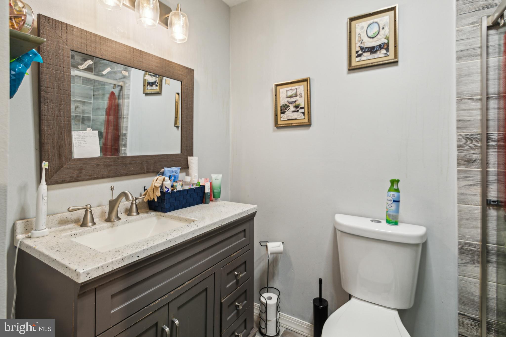 1008 Timber Creek Road Clementon, NJ 08021 - Photo 4 of 24 a bathroom with a granite countertop toilet sink and a mirror
