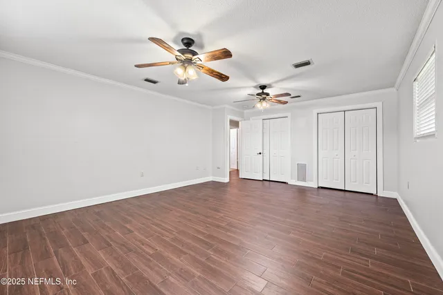 a bathroom with a granite countertop double vanity sink and mirror