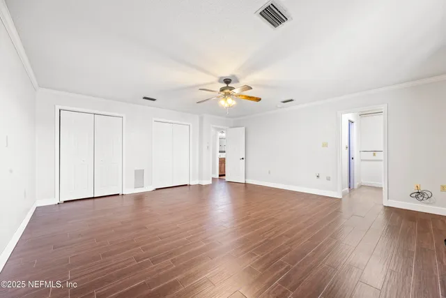 a view of walk in closet with empty racks