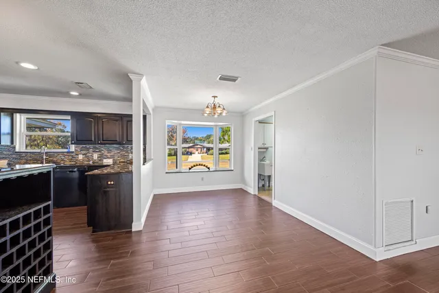 a large kitchen with stainless steel appliances granite countertop a refrigerator and a stove top oven