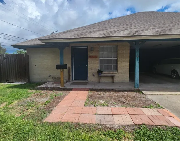 a view of a hallway with wooden floor and windows