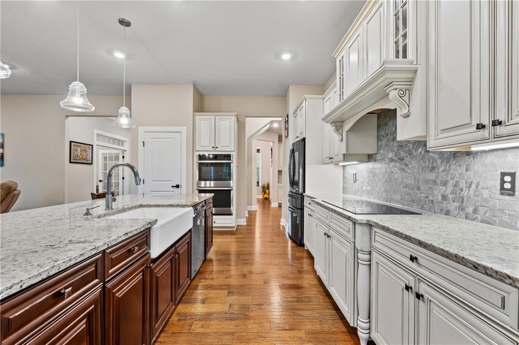 2009 Cherry Road Gibsonia, PA 15044 - Photo 15 of 45 a view of a kitchen with stainless steel appliances granite countertop a sink dishwasher a stove and a dining table with wooden floor