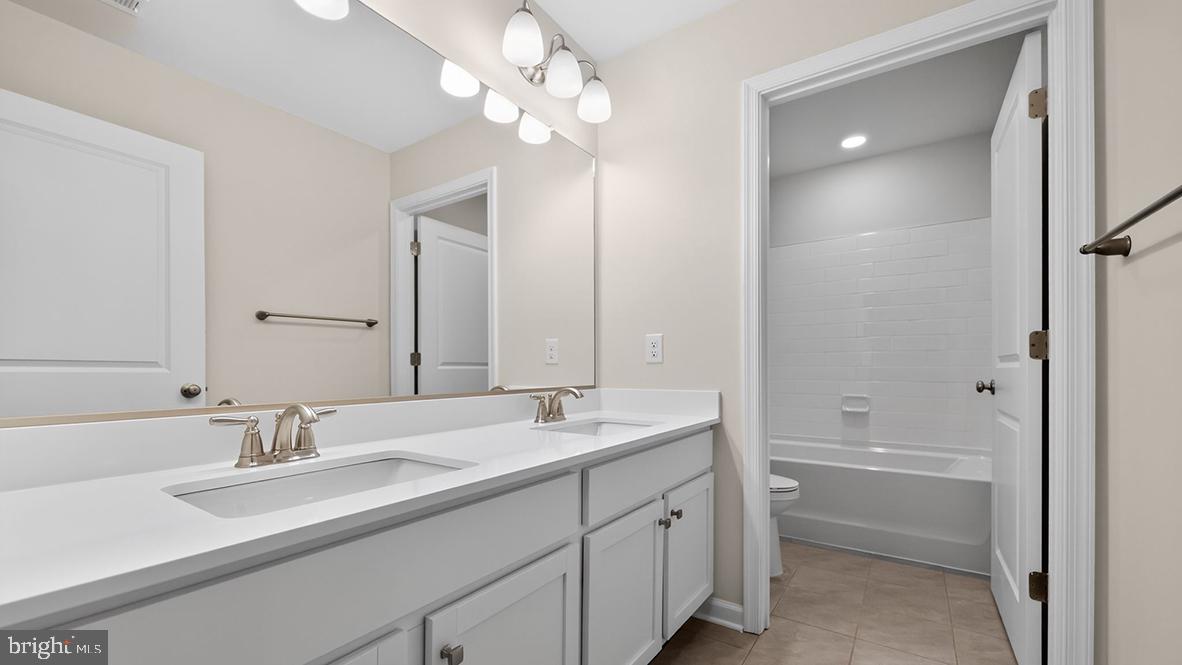 32 Georgetown Drive Freehold, NJ 07728 - Photo 26 of 37 a bathroom with a sink double vanity granite tub and a mirror