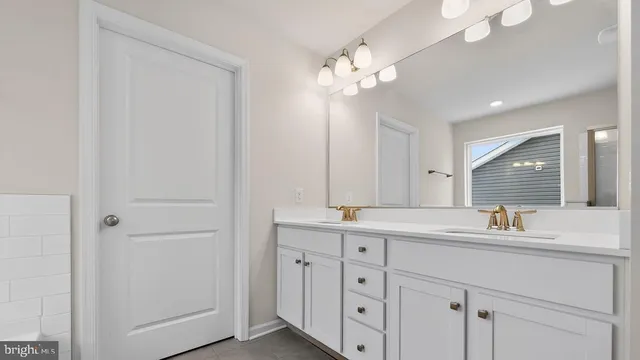 a bathroom with a sink a mirror and a double vanity