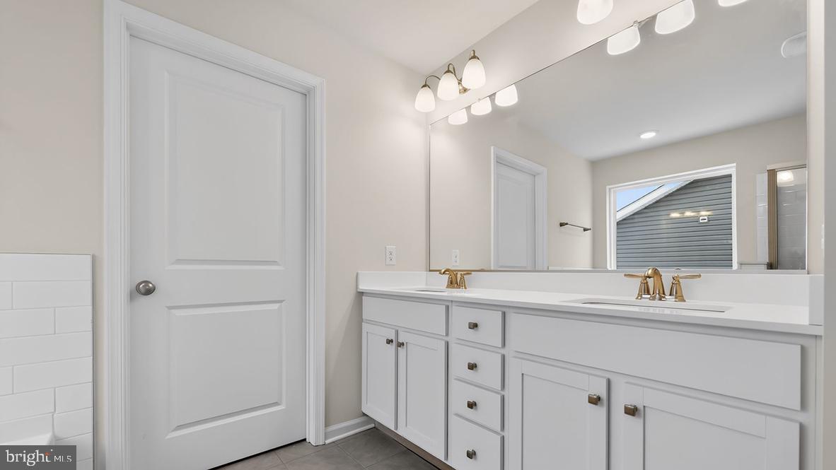 32 Georgetown Drive Freehold, NJ 07728 - Photo 27 of 37 a bathroom with a sink a mirror and a double vanity