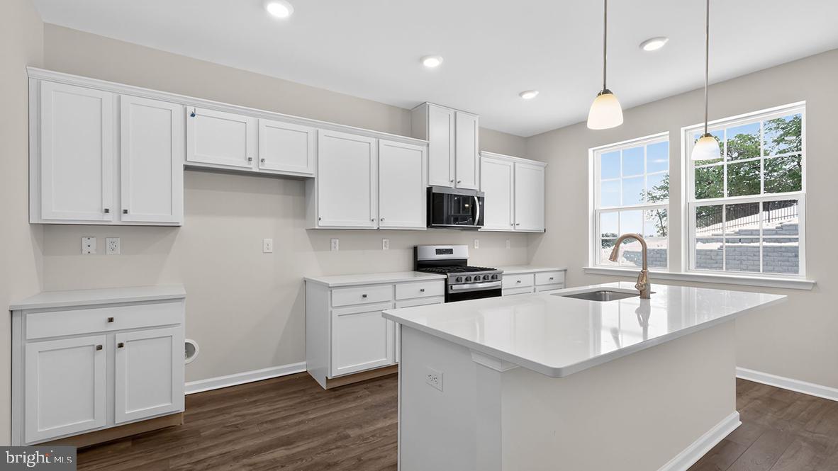 32 Georgetown Drive Freehold, NJ 07728 - Photo 3 of 37 a kitchen with granite countertop a sink a center island stainless steel appliances and cabinets