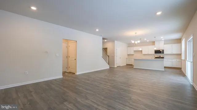 a view of a kitchen with a sink and a refrigerator