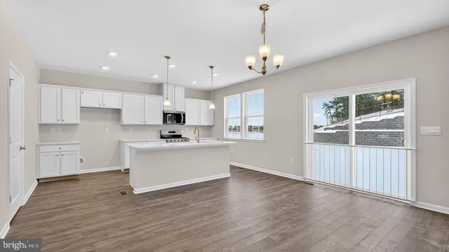 a view of a kitchen with marble kitchen and stainless steel appliances