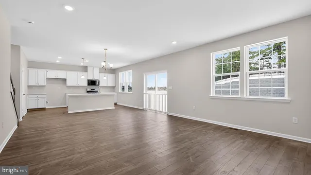 a view of a kitchen with a sink wooden floor and a kitchen