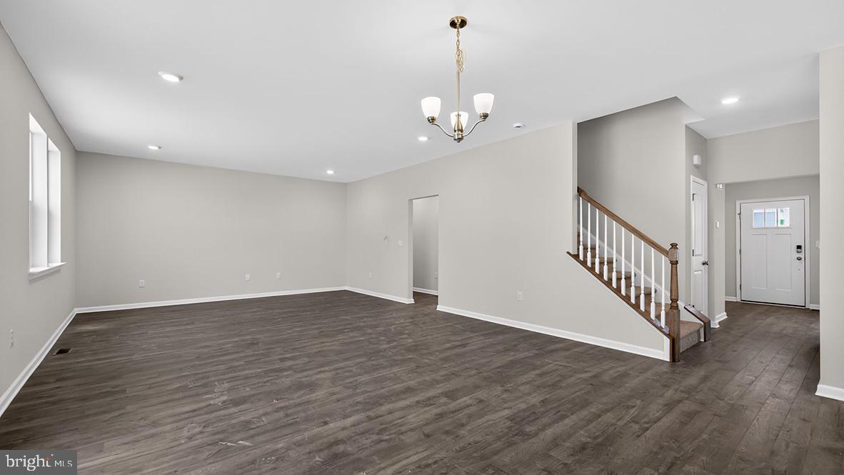 32 Georgetown Drive Freehold, NJ 07728 - Photo 6 of 37 a view of an empty room with wooden floor and staircase