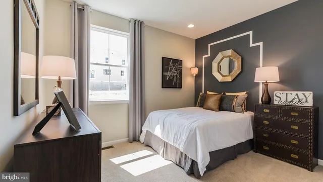 a bedroom with a bed and painting on the wall