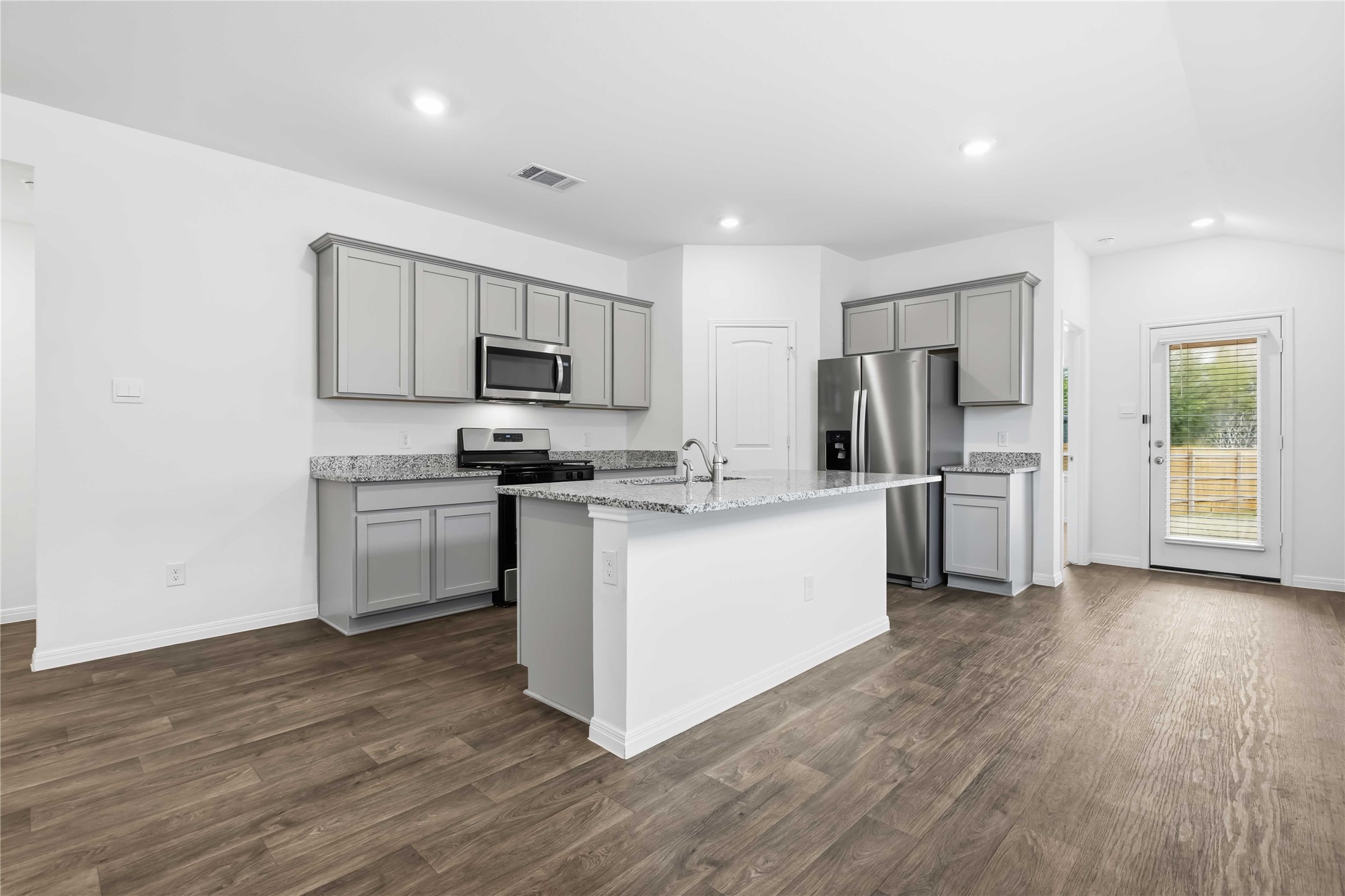 727 Gladiola Loop Kyle, TX 78640 - Photo 14 of 29 The kitchen is ready to use with desirable contemporary finishes and an island with bar seating perfect for causal meals and conversations.
