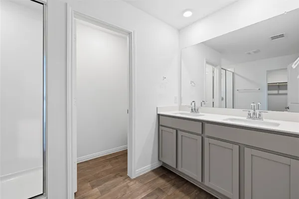 a bathroom with a double vanity sink and a mirror