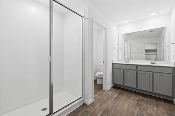a spacious bathroom with a double vanity sink and a mirror